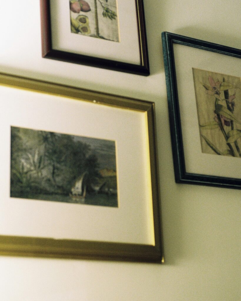 Strong glare and reflections on framed artworks hung on a wall