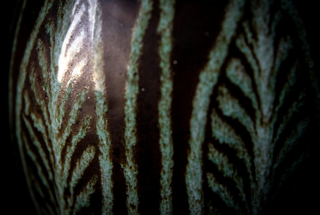 Low quality, overly close and distorted photo of an artwork surface